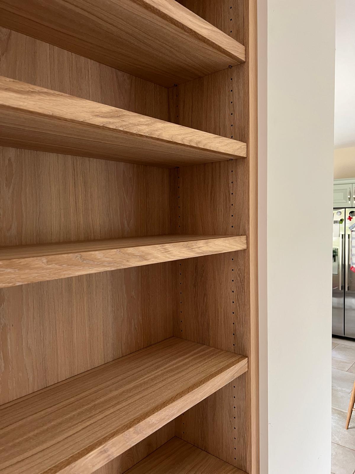 Close-up of solid oak bespoke shelving showing joinery and finish quality
