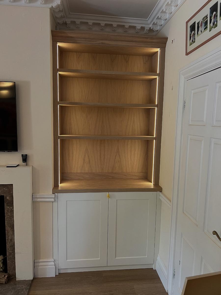Bespoke alcove bookshelf in oak with integrated LED lighting, handmade by CZ Bespoke Carpentry in Oxfordshire